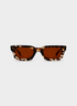 Tortoiseshell sunglasses with brown lenses on a white background