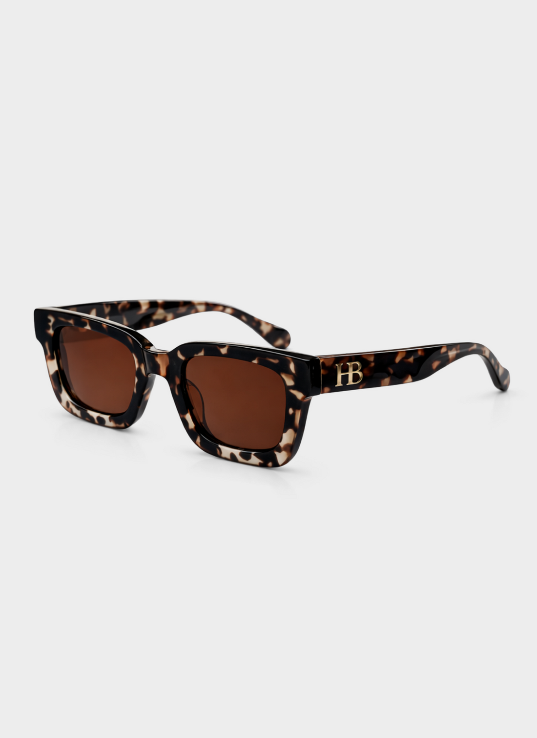 Sunglasses with tortoiseshell frame and brown lenses on a white background