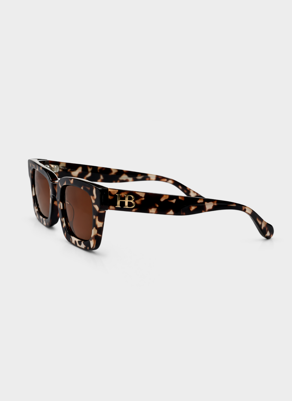 Sunglasses with tortoiseshell frame and brown lenses on a white background